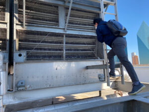 Plummer WEES team member inspects an industrial cooling tower to determine how it is running.