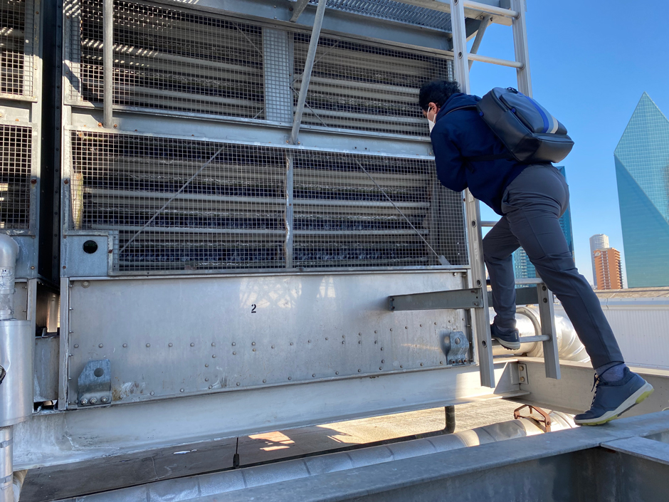 Plummer WEES team member inspects an industrial cooling tower to determine how it is running.