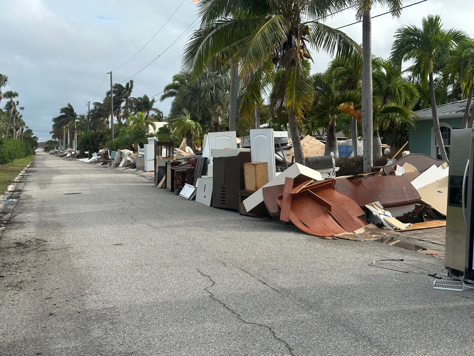 Photo of damaged furniture piled on the side of the road on Anna Maria Island following Hurricane Helene. 