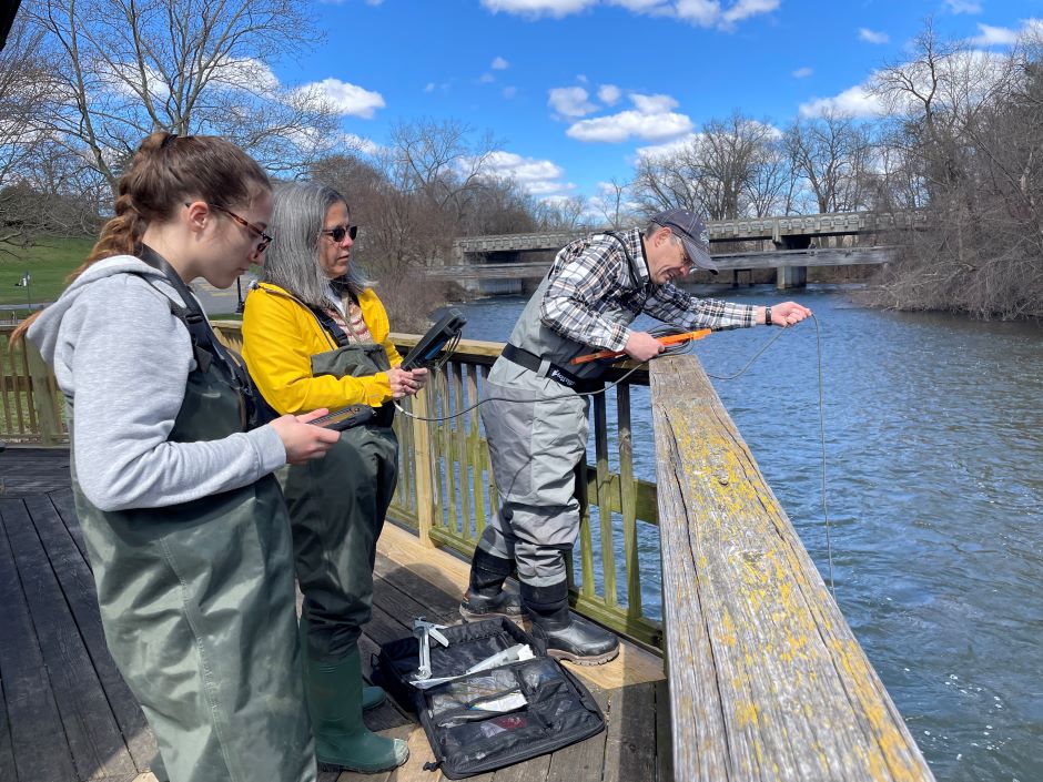 HRWC Chemistry and Flow volunteers lower the YSI ProQuatro probes into the main stem of the Huron River near downtown Ypsilanti, Michigan to record the LEVSN core parameters of pH, dissolved oxygen, water temperature, and conductivity. 