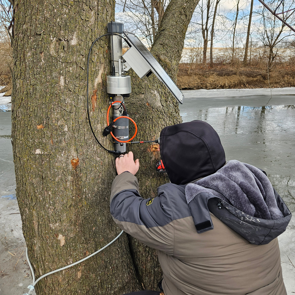 Tyler Keefer installing an X3 telemetry unit along the upper Conestoga River. 