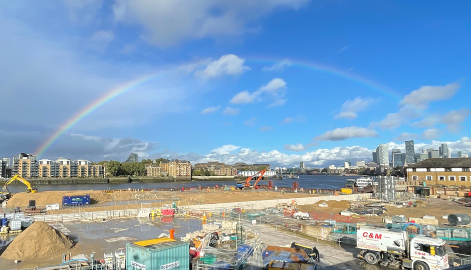 A rainbow crosses the Thames and construction site Chambers Wharf, Bermondsey, one of the four main drive sites on the Thames Tideway Tunnel project.